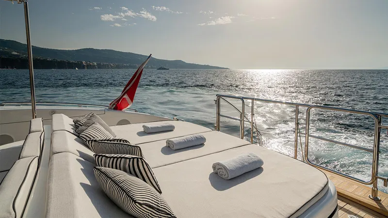 Deva I Yacht Photos Pics Luxurious 2008 Mangusta 92 yacht deck with sun loungers and ocean view.