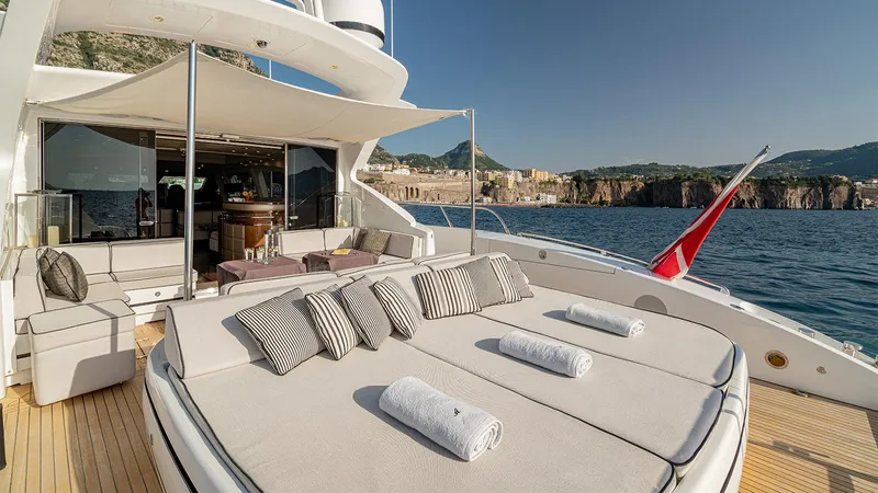 Deva I Yacht Photos Pics Luxurious 2008 Mangusta 92 yacht deck with sun loungers and scenic ocean view.