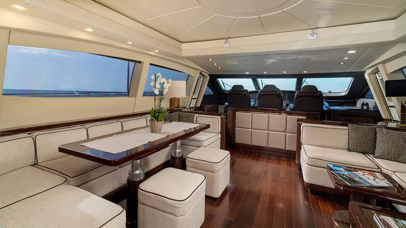 Deva I Yacht Photos Pics Luxurious interior of a 2008 Mangusta 92 yacht with elegant seating and dining area.