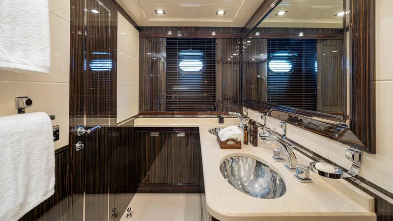 Deva I Yacht Photos Pics Luxurious bathroom interior of 2008 Mangusta 92 yacht with elegant fixtures and modern design.