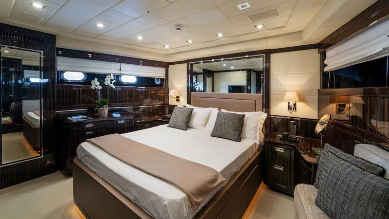Deva I Yacht Photos Pics Luxurious bedroom interior on 2008 Mangusta 92 yacht, featuring elegant decor and modern amenities.