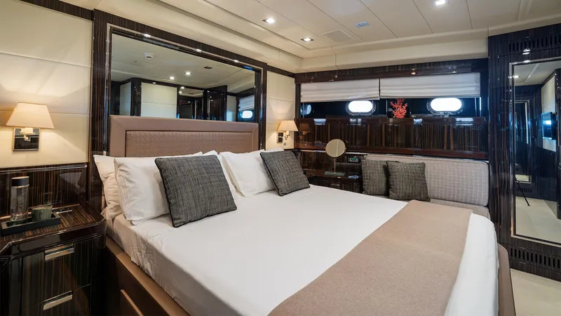 Deva I Yacht Photos Pics Luxurious bedroom interior on 2008 Mangusta 92 yacht, featuring elegant decor and comfortable bedding.