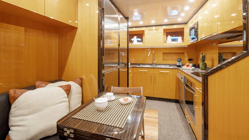 Deva I Yacht Photos Pics Luxurious interior of 2008 Mangusta 92 yacht with modern kitchen and dining area.