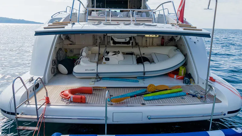 Deva I Yacht Photos Pics Luxury yacht Mangusta 92 (2008) with open garage, tender, and water sports equipment.