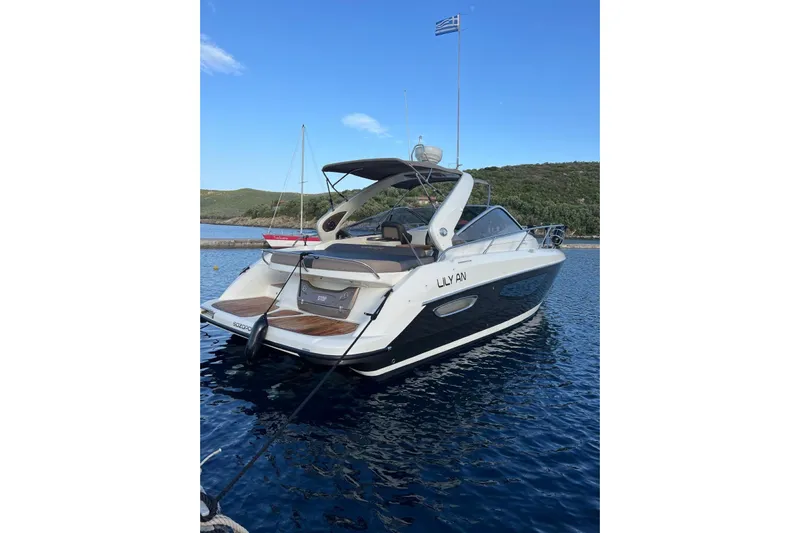  Yacht Photos Pics Luxury Crachi Endurance 33 yacht, 2009 model, docked in serene waters under a clear sky.
