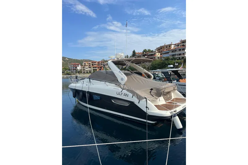  Yacht Photos Pics 2009 Crachi Endurance 33 yacht docked in a scenic marina with buildings in the background.