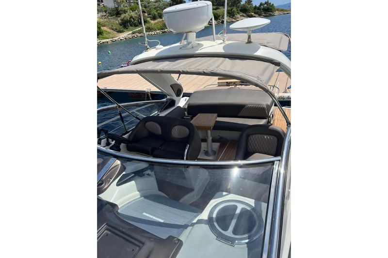  Yacht Photos Pics 2009 Crachi Endurance 33 boat interior with seating and table, docked by the water.