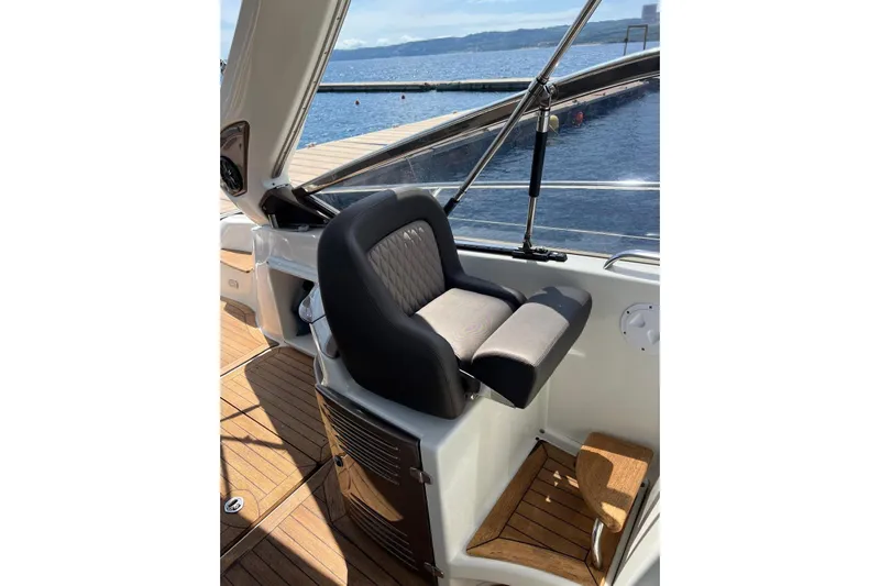  Yacht Photos Pics Captain's seat on 2009 Crachi Endurance 33 boat, overlooking serene waters.