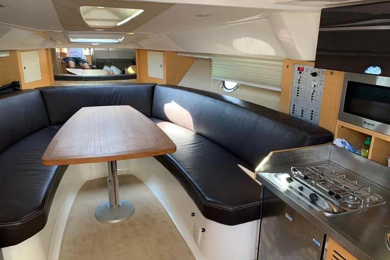  Yacht Photos Pics Interior of 2009 Crachi Endurance 33 yacht with dining area and compact kitchen.