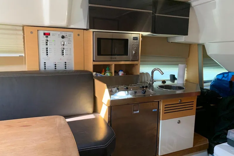  Yacht Photos Pics Interior of 2009 Crachi Endurance 33 yacht with kitchenette and seating area.