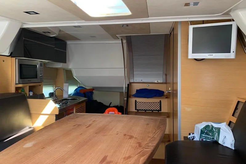  Yacht Photos Pics Interior of 2009 Crachi Endurance 33 yacht with kitchen, table, and TV.