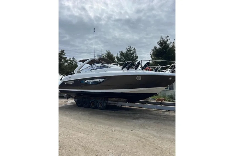  Yacht Photos Pics 2009 Crachi Endurance 33 yacht on trailer, parked outdoors under cloudy sky.