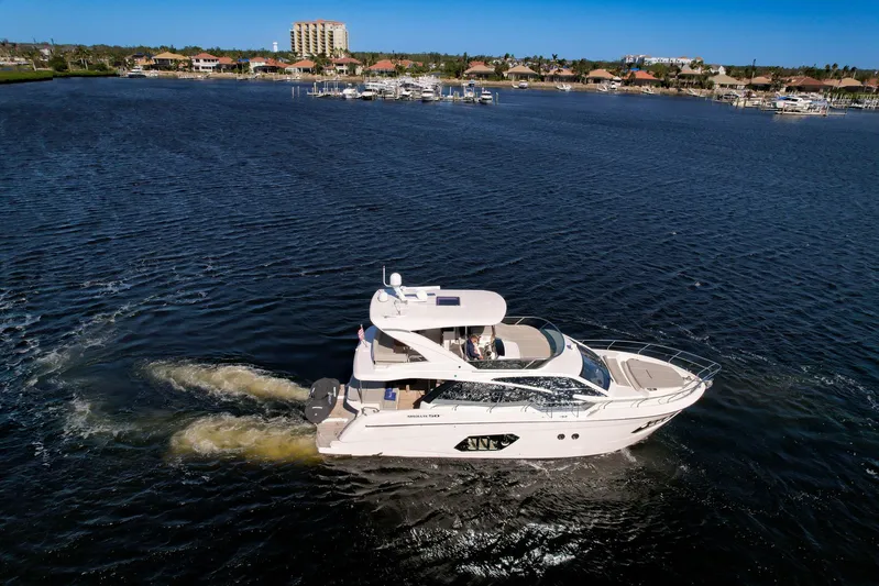  Yacht Photos Pics 2019 Absolute 50 Fly yacht cruising on a sunny day in a coastal area.