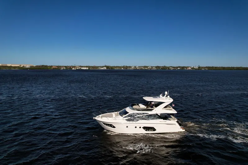  Yacht Photos Pics 2019 Absolute 50 Fly yacht cruising on open water under clear blue sky.