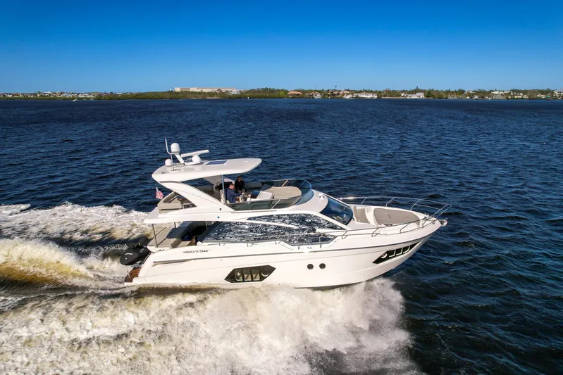  Yacht Photos Pics 2019 Absolute 50 Fly yacht cruising on open water under clear blue sky.