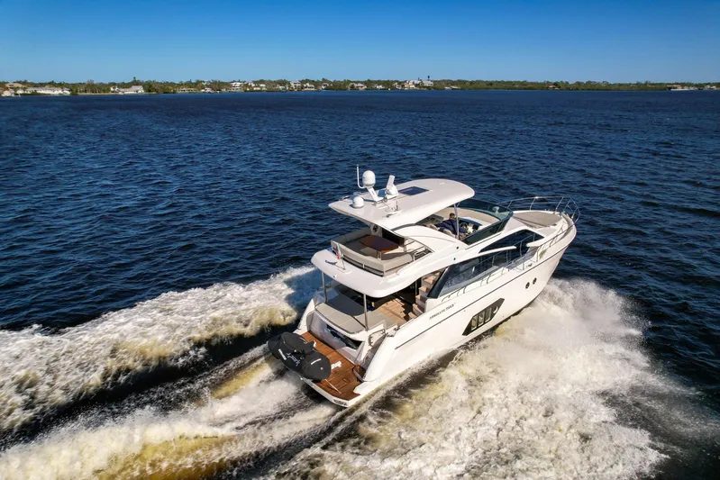 Yacht Photos Pics 2019 Absolute 50 Fly yacht cruising on open water, creating a wake.