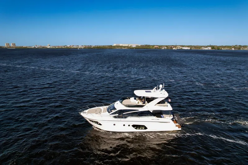  Yacht Photos Pics 2019 Absolute 50 Fly yacht cruising on open water under clear blue sky.