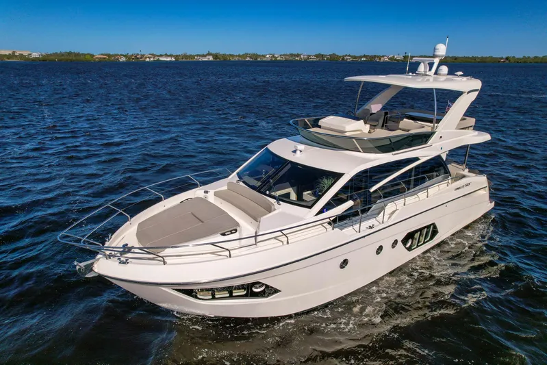  Yacht Photos Pics 2019 Absolute 50 Fly yacht cruising on open water under clear blue sky.