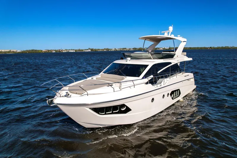  Yacht Photos Pics 2019 Absolute 50 Fly yacht cruising on open water under clear blue sky.