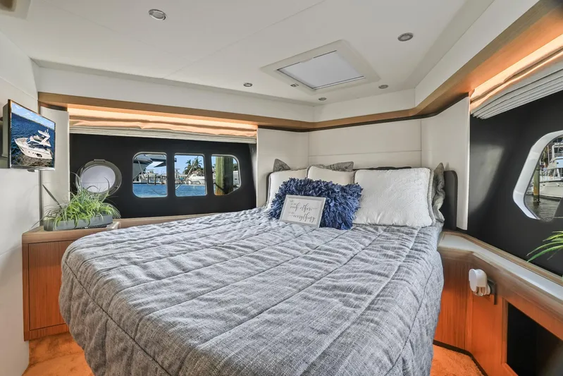  Yacht Photos Pics Luxurious bedroom interior of 2019 Absolute 50 Fly yacht with large windows and modern decor.
