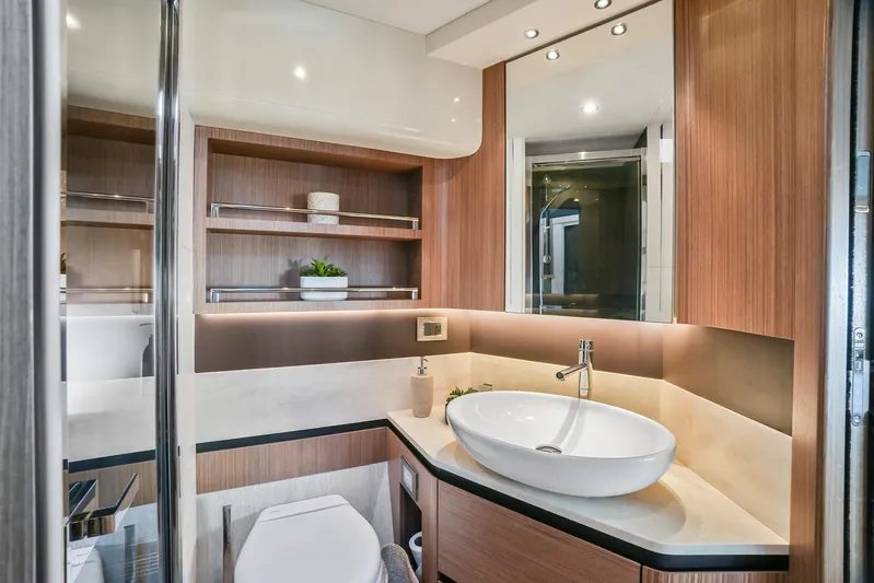  Yacht Photos Pics Luxurious bathroom interior on 2019 Absolute 50 Fly yacht, featuring modern sink and elegant wood finishes.