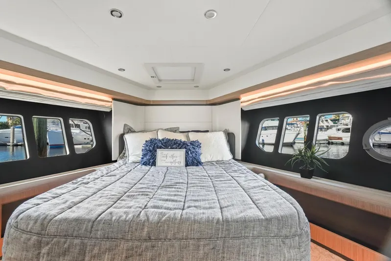  Yacht Photos Pics Luxurious bedroom interior of 2019 Absolute 50 Fly yacht with large windows and modern decor.