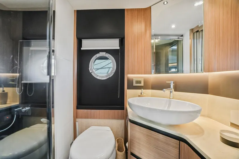  Yacht Photos Pics Luxurious bathroom in 2019 Absolute 50 Fly yacht with modern fixtures and porthole window.