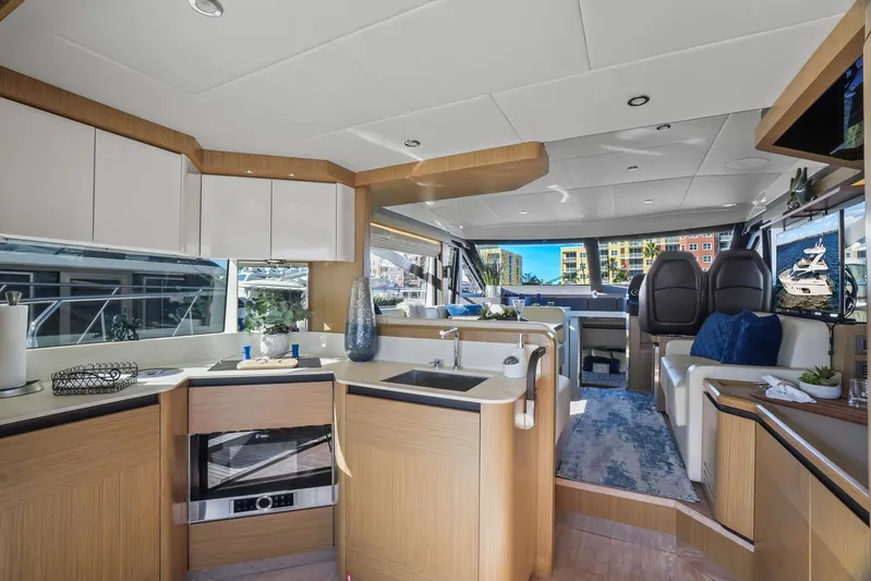  Yacht Photos Pics Luxurious interior of a 2019 Absolute 50 Fly yacht with modern kitchen and seating area.
