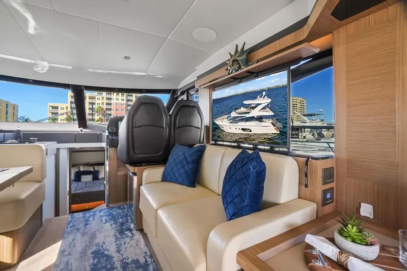  Yacht Photos Pics Luxurious interior of 2019 Absolute 50 Fly yacht with modern seating and scenic window view.