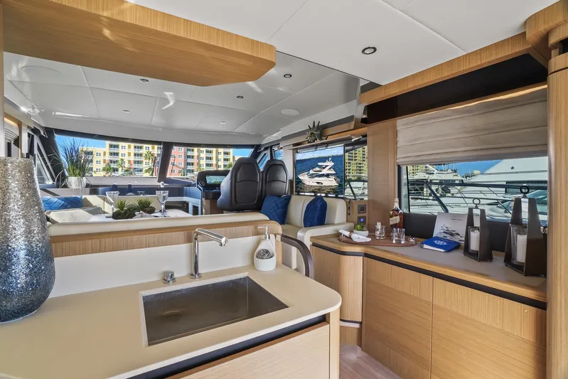  Yacht Photos Pics Luxurious interior of a 2019 Absolute 50 Fly yacht with modern kitchen and seating area.