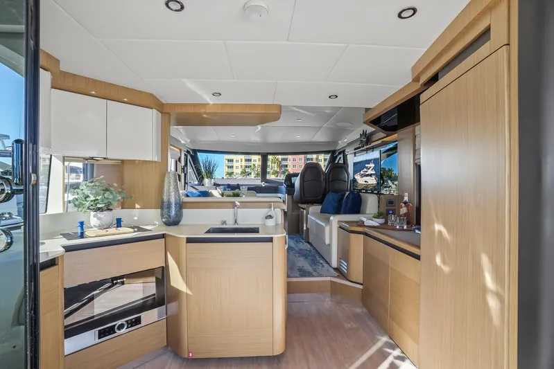  Yacht Photos Pics Luxurious interior of a 2019 Absolute 50 Fly yacht with modern kitchen and seating area.