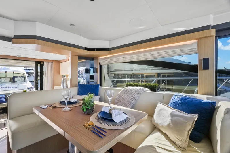  Yacht Photos Pics Luxurious interior of 2019 Absolute 50 Fly yacht with elegant dining setup.