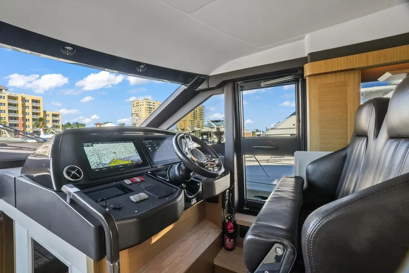 Yacht Photos Pics Interior helm of 2019 Absolute 50 Fly yacht with modern controls and leather seating.