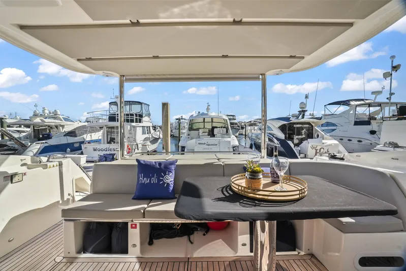  Yacht Photos Pics Luxurious 2019 Absolute 50 Fly yacht interior with marina view, featuring elegant seating and table setup.