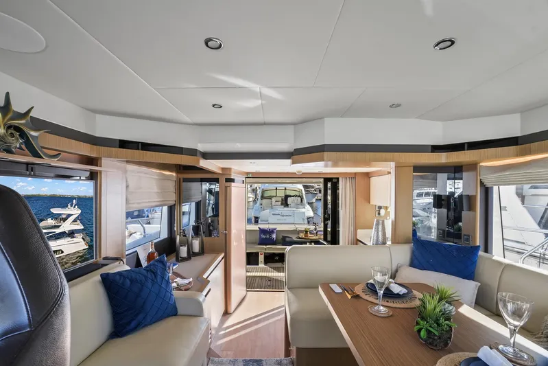  Yacht Photos Pics Luxurious interior of 2019 Absolute 50 Fly yacht with elegant dining area and scenic views.