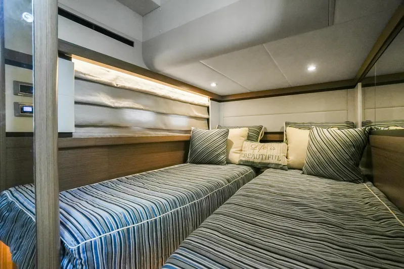  Yacht Photos Pics Luxurious twin cabin interior of 2019 Absolute 50 Fly yacht with striped bedding.