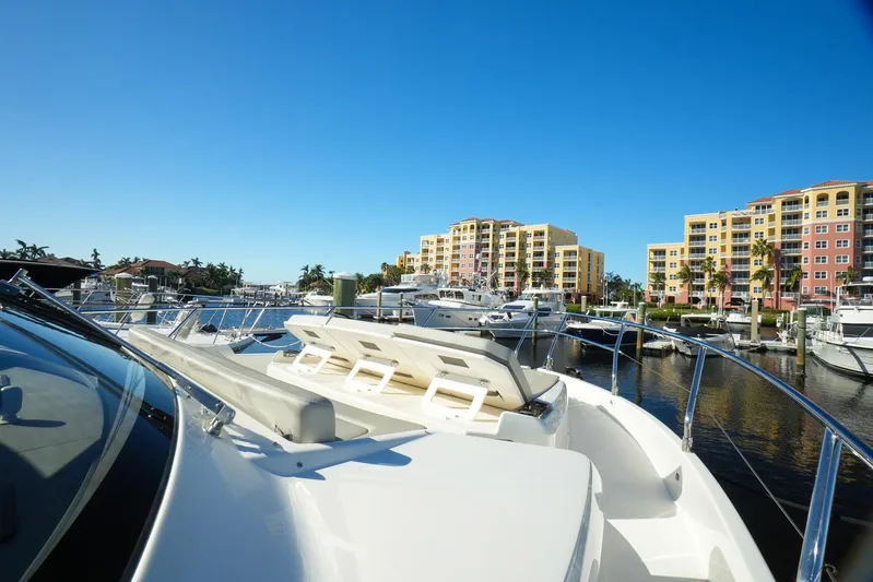  Yacht Photos Pics 2019 Absolute 50 Fly yacht docked in a sunny marina with buildings in the background.