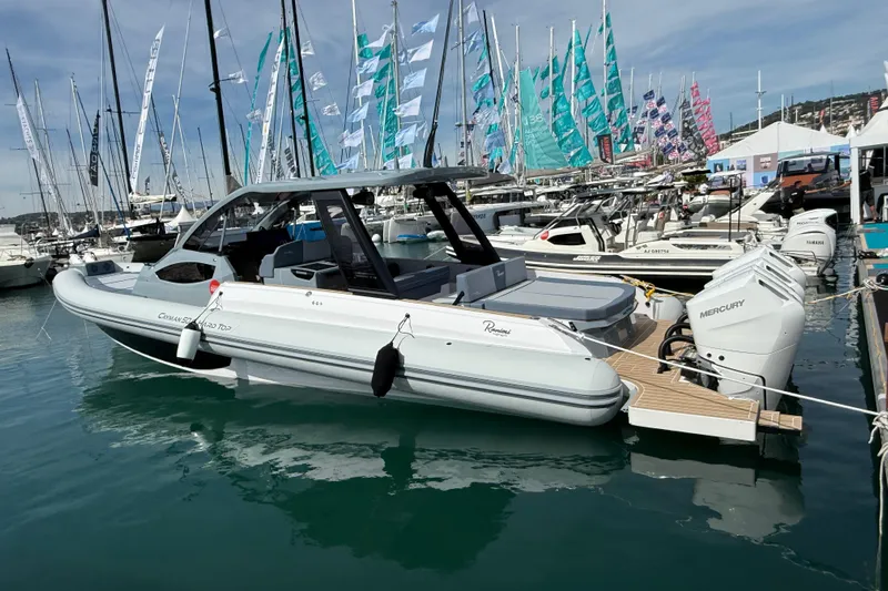  Yacht Photos Pics 2026 Ranieri CAYMAN 50.0 HARD TOP boat docked at marina with colorful flags.