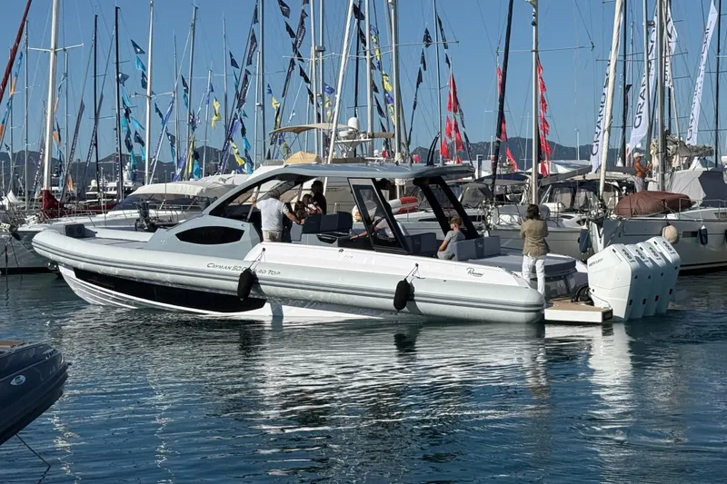  Yacht Photos Pics 2026 Ranieri CAYMAN 50.0 HARD TOP yacht docked at marina with flags and people onboard.