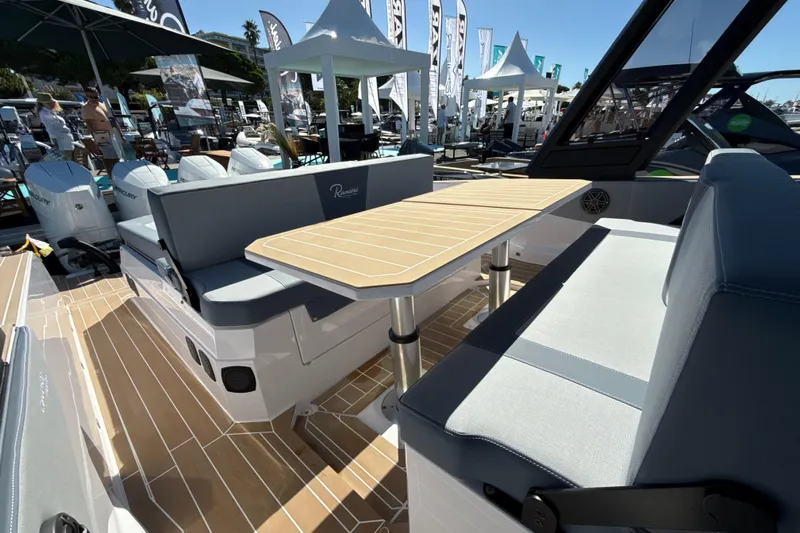  Yacht Photos Pics Luxury seating area on 2026 Ranieri CAYMAN 50.0 HARD TOP yacht, featuring elegant wood table.