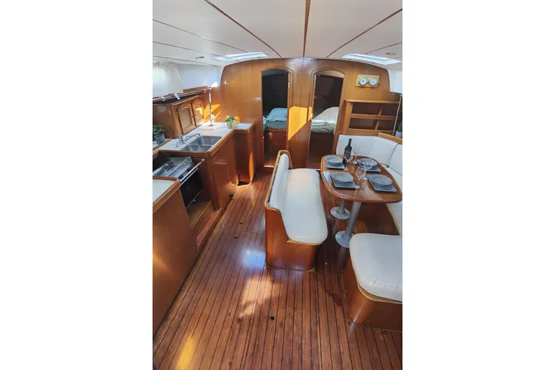  Yacht Photos Pics Interior of 1997 Beneteau Oceanis 461 yacht with wooden flooring and dining area.