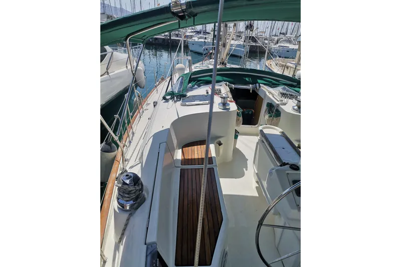  Yacht Photos Pics 1997 Beneteau Oceanis 461 sailboat deck with green canopy and wooden accents.
