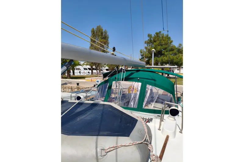  Yacht Photos Pics 1997 Beneteau Oceanis 461 sailboat with green canopy, docked outdoors.