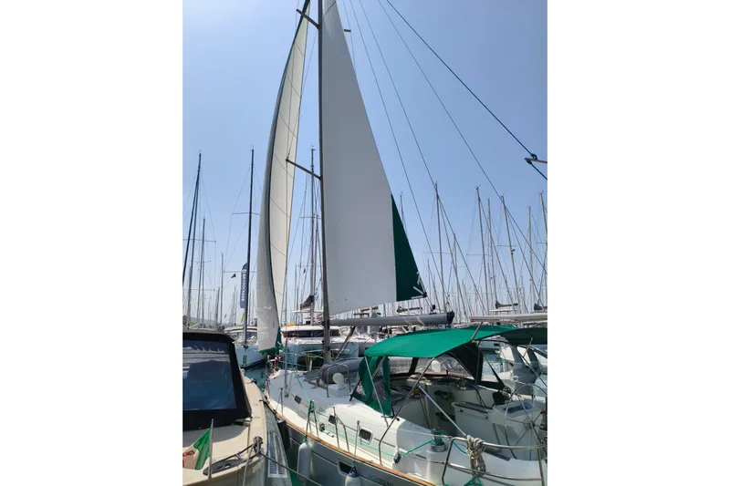  Yacht Photos Pics 1997 Beneteau Oceanis 461 sailboat docked with sails raised under clear sky.
