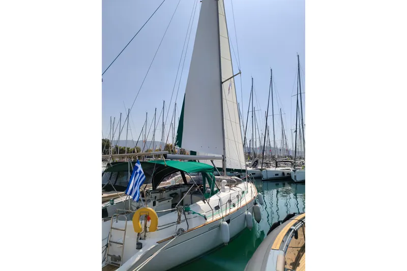  Yacht Photos Pics 1997 Beneteau Oceanis 461 sailboat docked in marina with Greek flag.