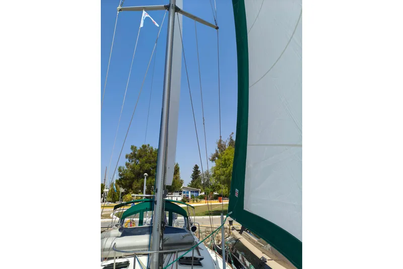  Yacht Photos Pics Sailboat Beneteau Oceanis 461, 1997 model, with green sail and clear blue sky.