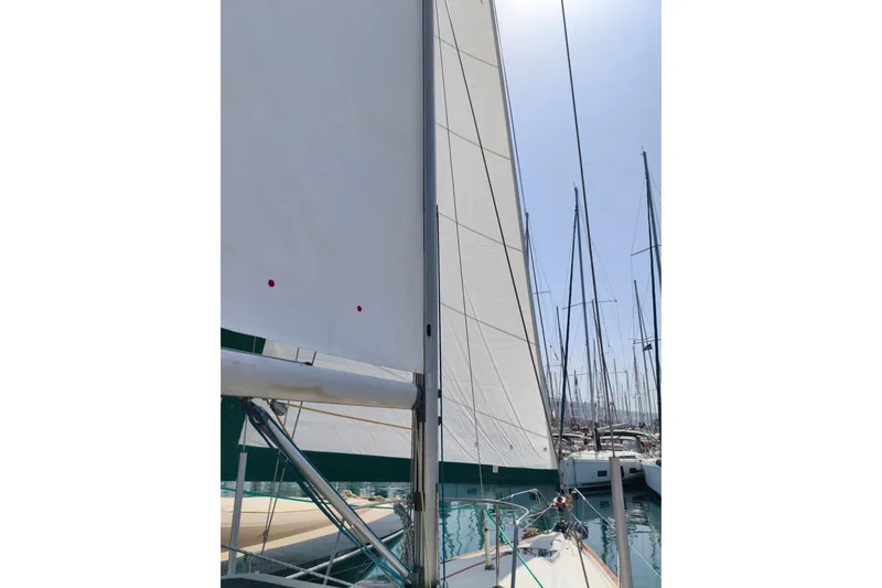  Yacht Photos Pics Sailboat Beneteau Oceanis 461, 1997 model, docked with sails raised in a marina.