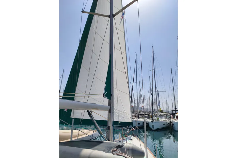  Yacht Photos Pics Sailboat Beneteau Oceanis 461, 1997 model, docked in a marina with raised sails.