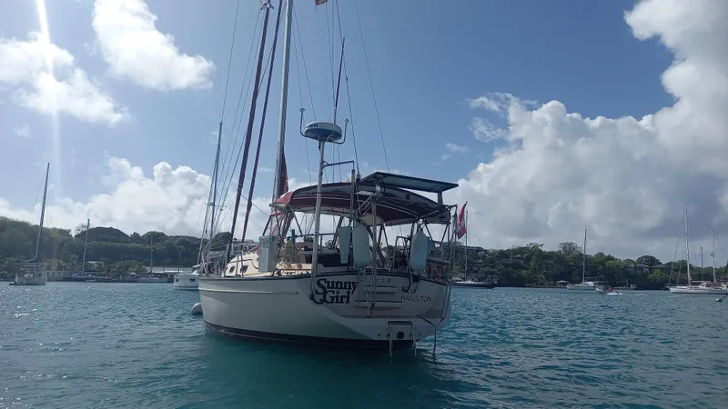 Sunny Girl Yacht Photos Pics Island Packet 370 sailboat from 2004 anchored in a scenic bay.