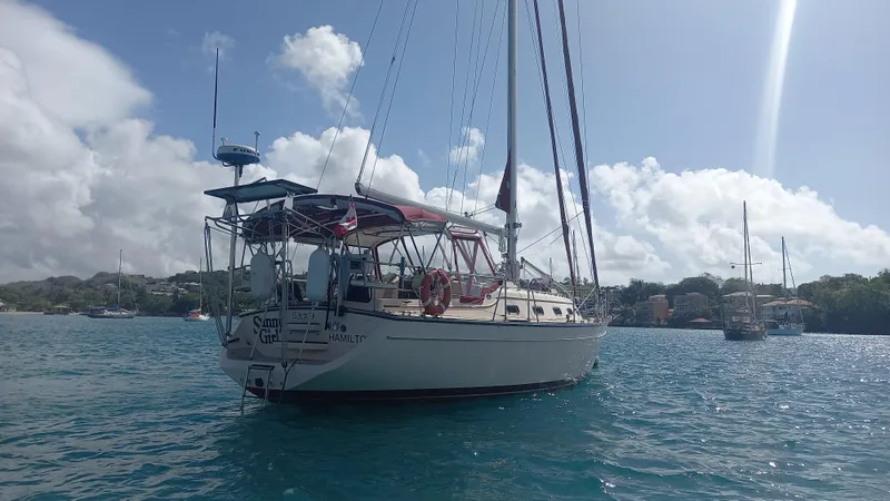 Sunny Girl Yacht Photos Pics Sailboat Island Packet 370, 2004 model, anchored in sunny waters with clear skies.